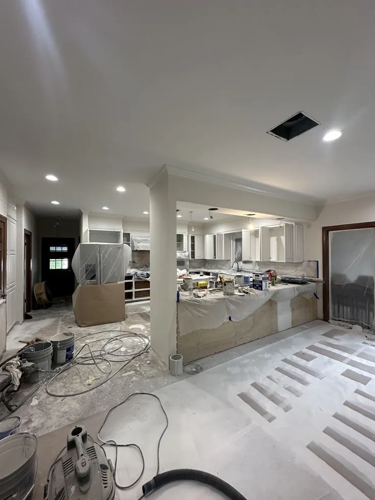 Apartment interior during renovation work, with flooring and finishing in progress